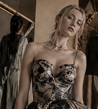 Patterned fitted dress with layered jewellery